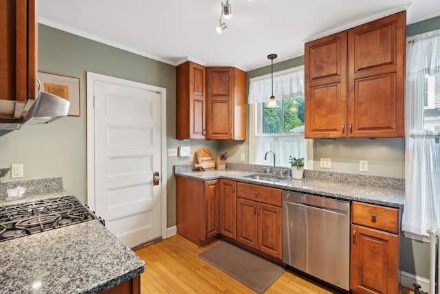 kitchen featuring pendant lighting, sink, stone countertops, stainless steel dishwasher, and light wood-type flooring