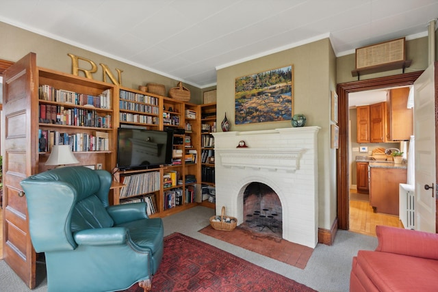 living area featuring light carpet, a brick fireplace, and crown molding