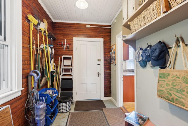 mudroom featuring ornamental molding and wooden walls