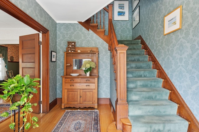 staircase with hardwood / wood-style flooring