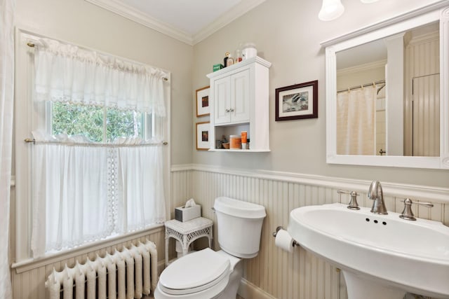 bathroom featuring sink, radiator heating unit, ornamental molding, and toilet