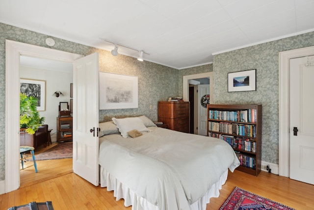 bedroom featuring crown molding and wood-type flooring