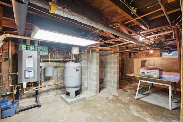 basement with a healthy amount of sunlight and water heater