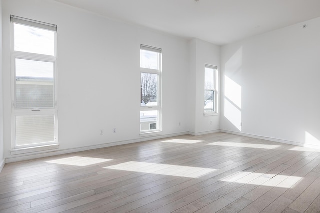 empty room with light hardwood / wood-style floors