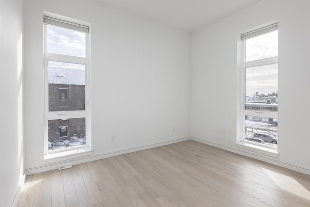 spare room with light hardwood / wood-style floors