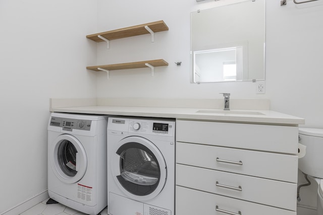 clothes washing area featuring washer and dryer and sink