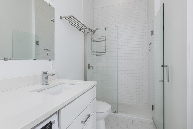 bathroom featuring vanity, an enclosed shower, and toilet