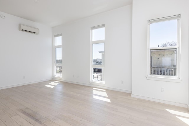 1 Joy Pl Unit 3A, Portland, ME 04102 - unfurnished room with baseboards, light wood-type flooring, and a wall mounted air conditioner
