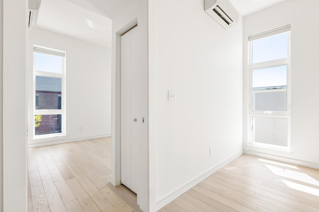 1 Joy Pl Unit 3A, Portland, ME 04102 - corridor featuring baseboards, a wall unit AC, light wood-style flooring, and plenty of natural light