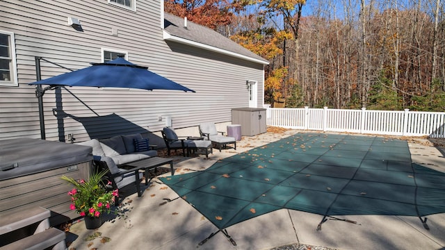 view of swimming pool featuring an outdoor living space and a hot tub