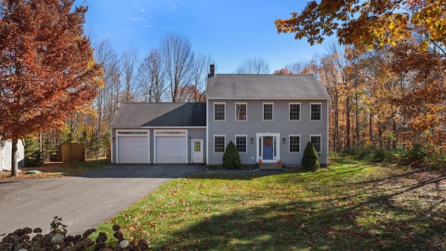 view of front of house with a garage and a front yard