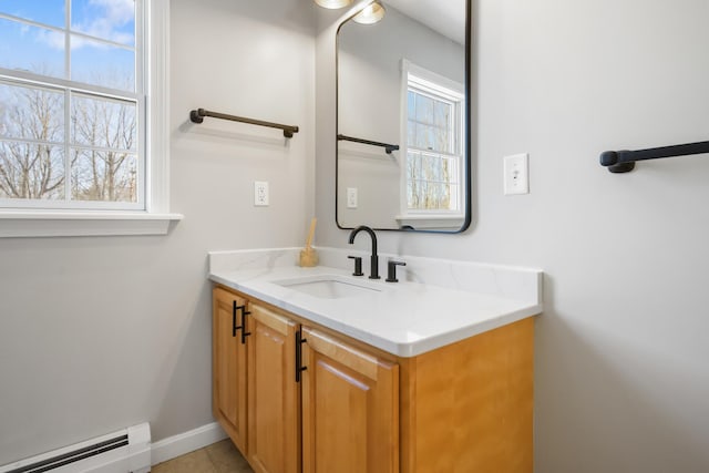 bathroom with baseboard heating, vanity, and tile patterned flooring