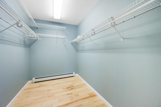 spacious closet with baseboard heating and hardwood / wood-style floors