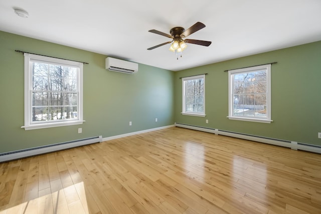 unfurnished room featuring light hardwood / wood-style flooring, a baseboard radiator, and a wall unit AC