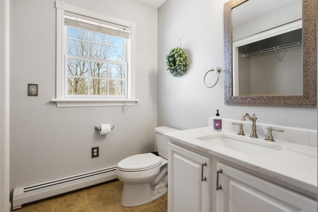 bathroom with vanity, tile patterned floors, toilet, and baseboard heating