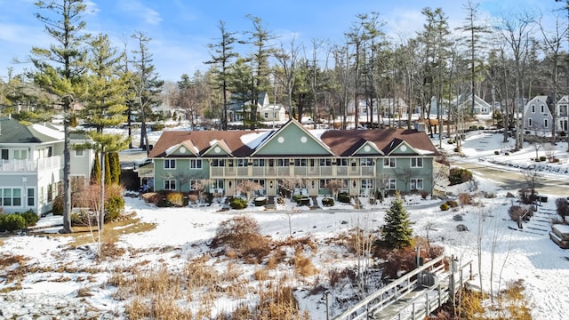 view of snow covered back of property