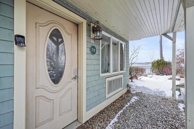 view of snow covered property entrance