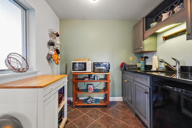 kitchen featuring sink, gray cabinets, black dishwasher, and plenty of natural light