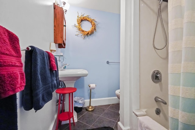 bathroom featuring shower / bathtub combination with curtain, tile patterned floors, and toilet