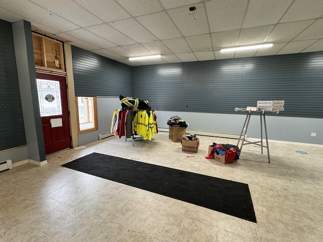 game room featuring a drop ceiling and a baseboard radiator