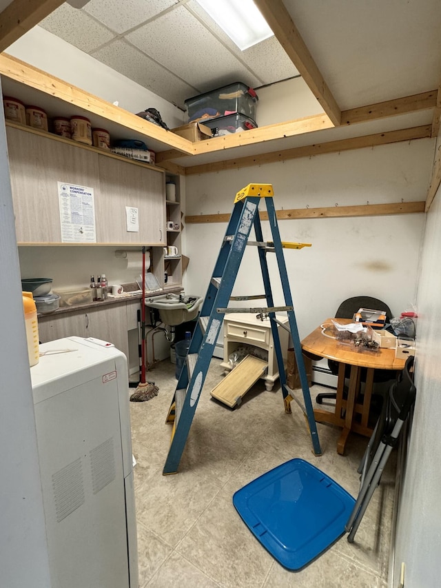 basement with washer / clothes dryer and a drop ceiling