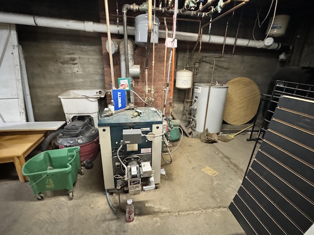 utility room featuring water heater