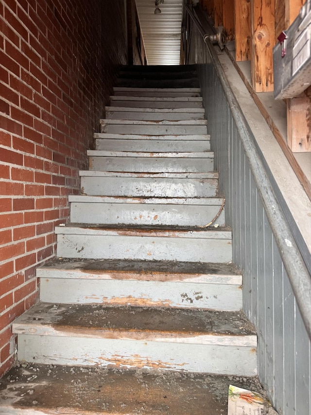 staircase with brick wall