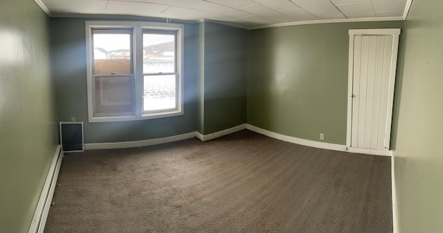 carpeted empty room featuring baseboard heating and ornamental molding