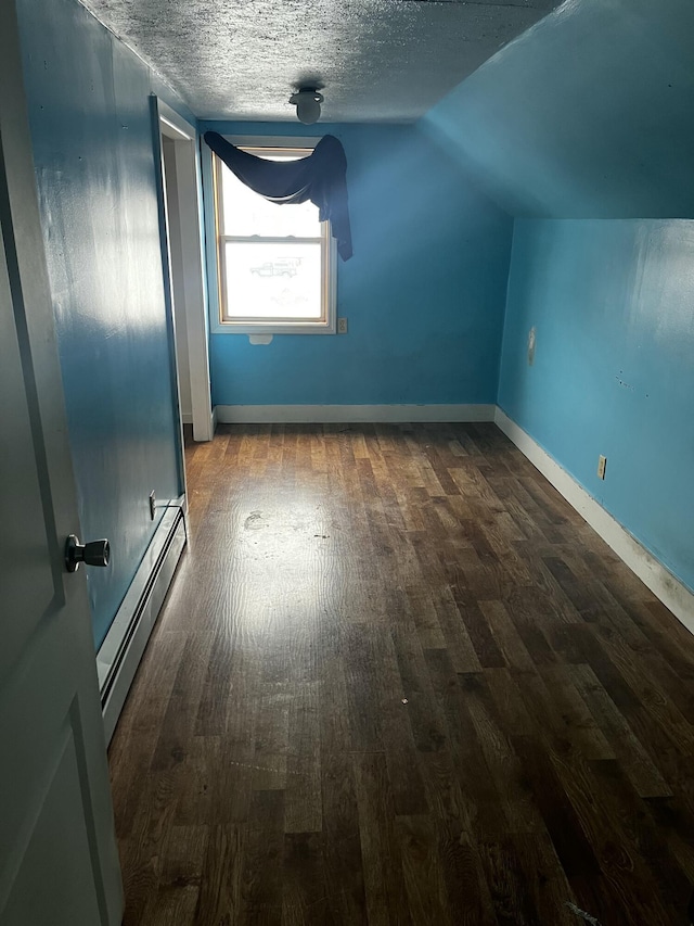 bonus room with a baseboard radiator, lofted ceiling, hardwood / wood-style floors, and a textured ceiling