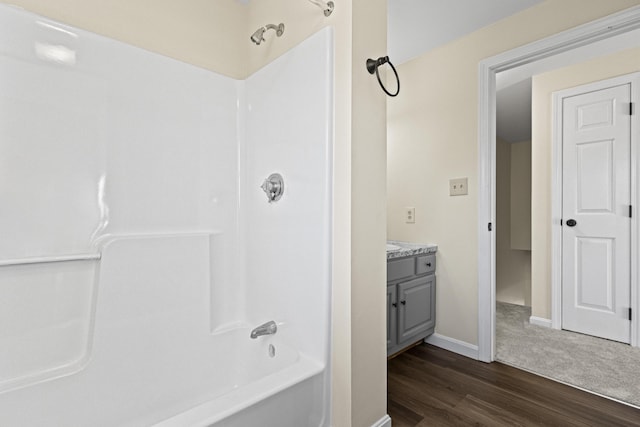 bathroom with hardwood / wood-style flooring, vanity, and  shower combination