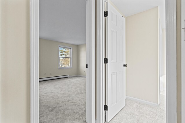 corridor featuring light colored carpet and a baseboard radiator