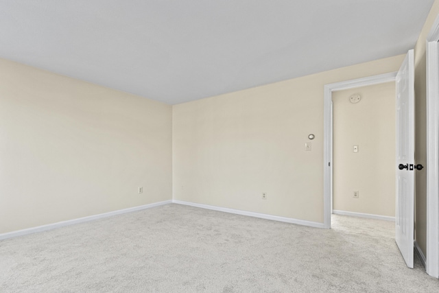 spare room with light colored carpet