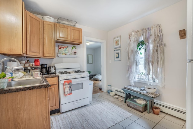 kitchen featuring baseboard heating, white gas range, sink, and light tile patterned floors