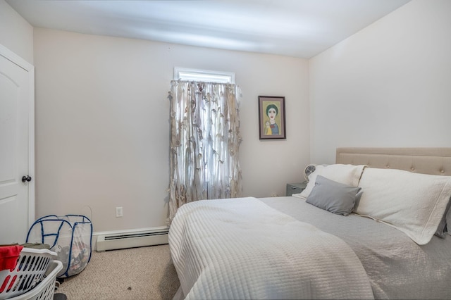 carpeted bedroom featuring a baseboard heating unit