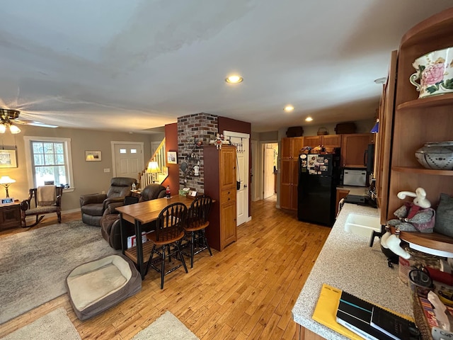 interior space with ceiling fan and light wood-type flooring