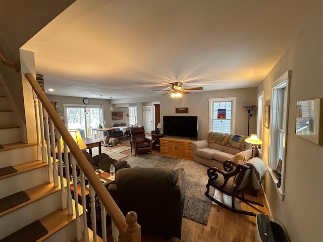 living room featuring ceiling fan and light wood-type flooring