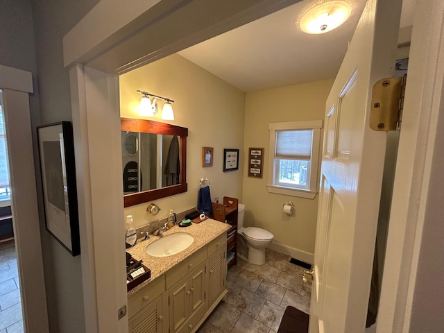 bathroom featuring vanity and toilet