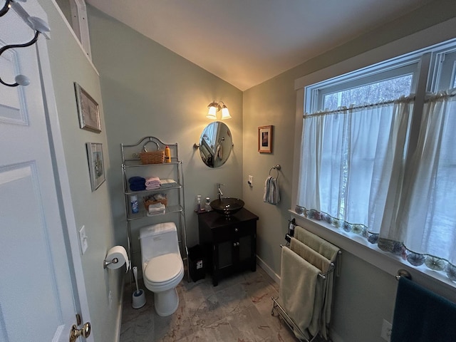 bathroom with vanity, lofted ceiling, radiator heating unit, and toilet