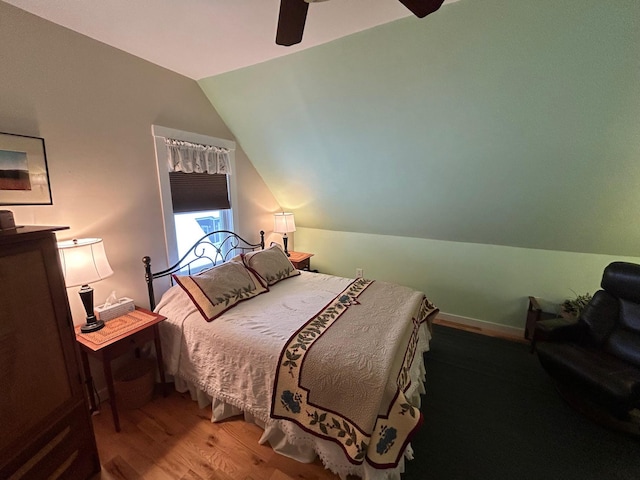 bedroom featuring vaulted ceiling, hardwood / wood-style floors, and ceiling fan