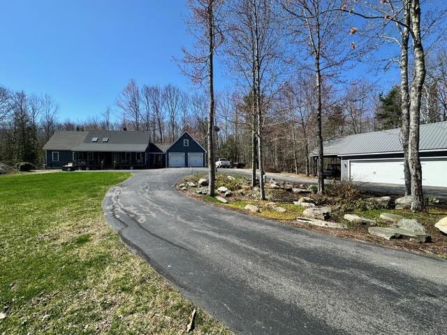 21 Dream Ln, Belfast, ME 04915 - view of front of house with a front yard, asphalt driveway, and metal roof