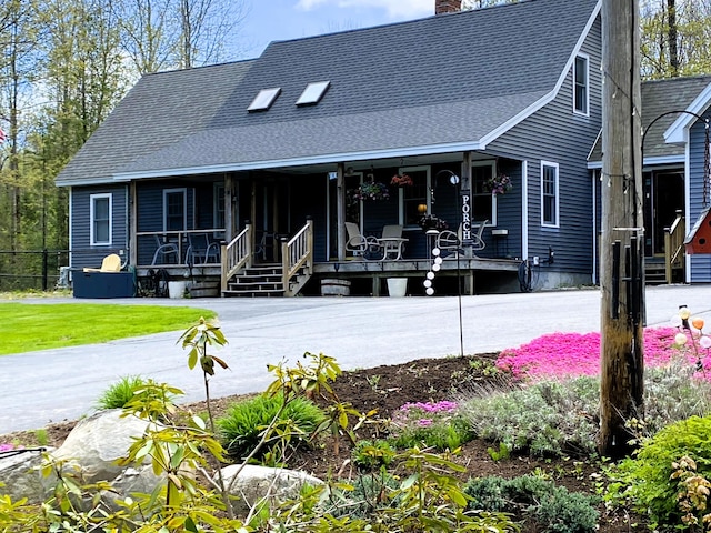 21 Dream Ln, Belfast, ME 04915 - view of front of property with covered porch, a chimney, and roof with shingles