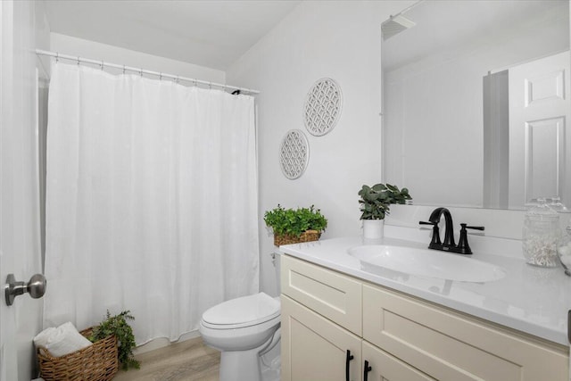 bathroom with vanity, hardwood / wood-style floors, and toilet