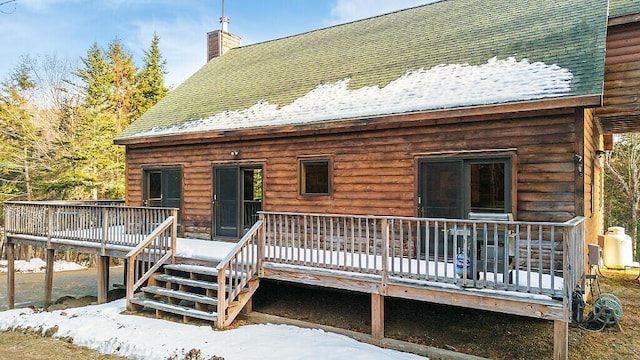 snow covered property featuring a deck