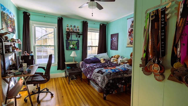 bedroom with ceiling fan, ornamental molding, and hardwood / wood-style floors