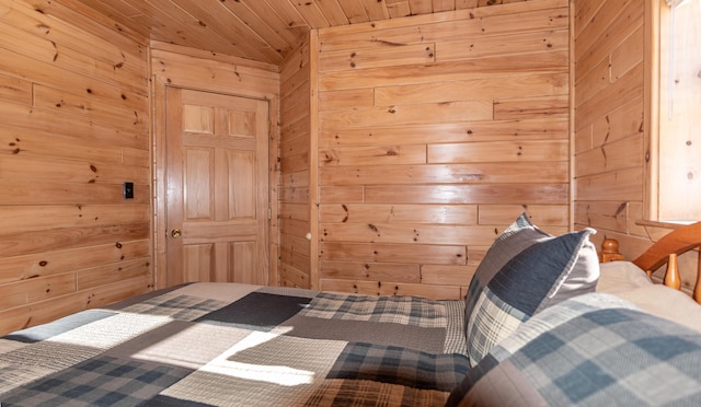 bedroom featuring wooden walls and wooden ceiling