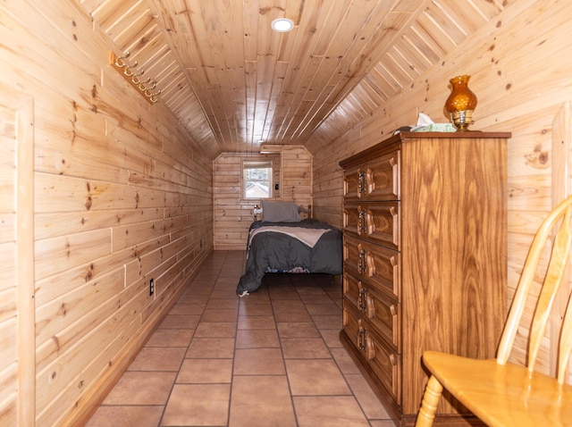 unfurnished bedroom featuring tile patterned flooring, vaulted ceiling, wooden ceiling, and wood walls