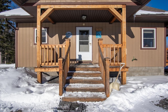 view of snow covered property entrance