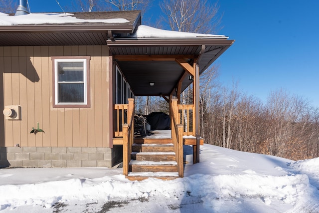 view of snow covered property entrance