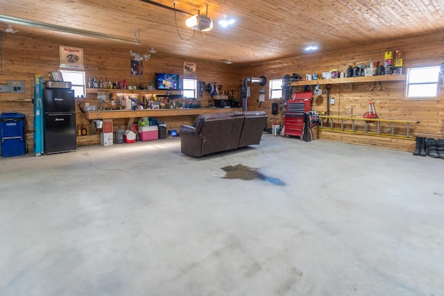 garage with a garage door opener, wood ceiling, and a workshop area