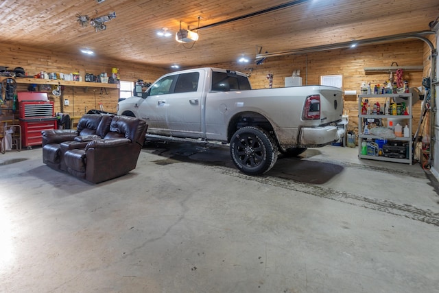 garage featuring wood ceiling, a garage door opener, wooden walls, and a workshop area